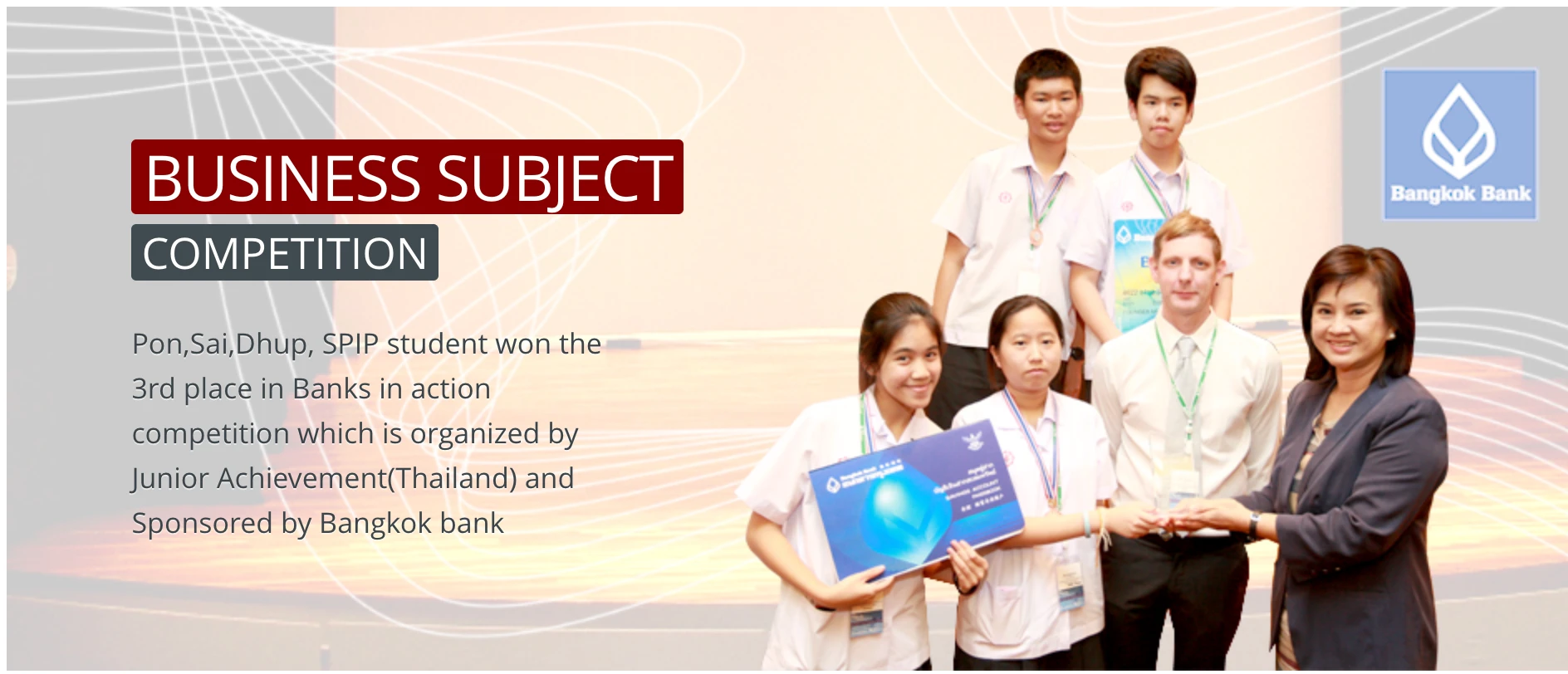SPIP school slide announcing third place in Banks in Action, with the team holding a Bangkok Bank prize board. Slide text: "BUSINESS SUBJECT COMPETITION" and "Pon,Sai,Dhup, SPIP student won the 3rd place in Banks in action competition which is organized by Junior Achievement(Thailand) and Sponsored by Bangkok bank"