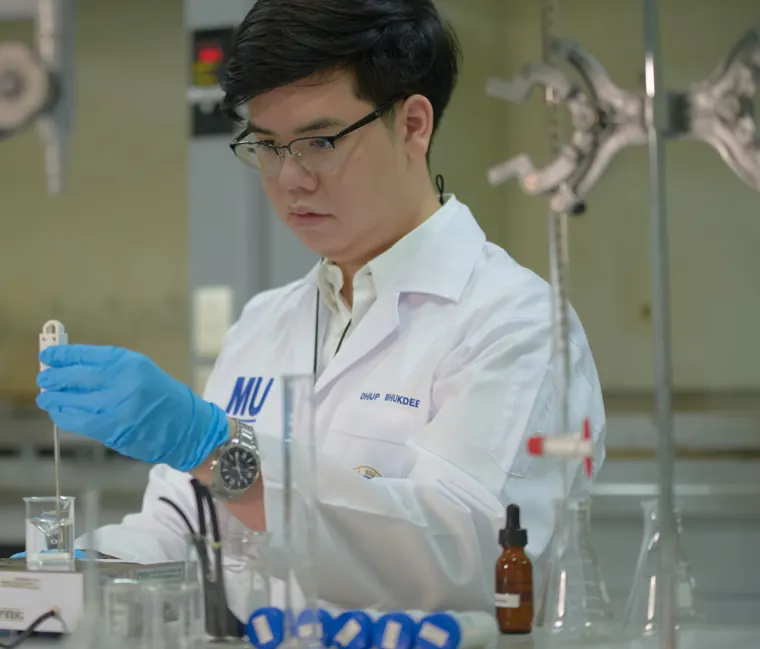 Dhup carrying out his chemistry experiment at a laboratory bench